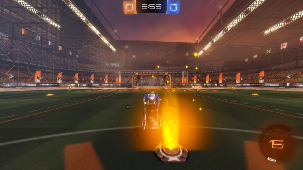 Carro azul acelera em direção ao gol adversário em partida de Rocket League, coletando boost no centro da arena durante um lance competitivo com placar empatado em 0 a 0.
